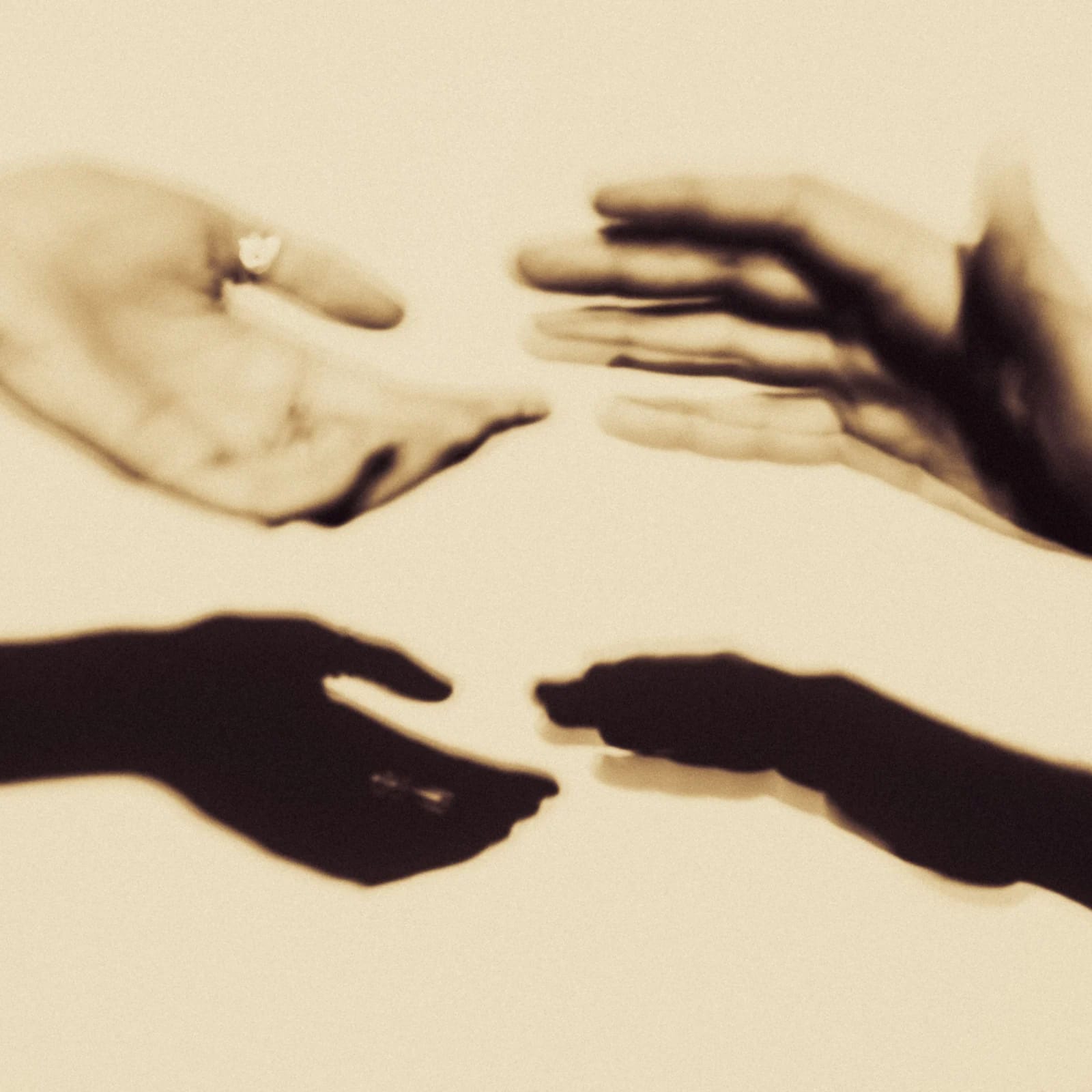 Dear Love cover art: four hands reaching toward each other in sepia
